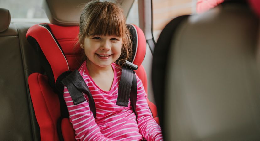 Cute girl buckled into her car seat