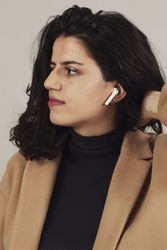 Woman with earbuds in studio