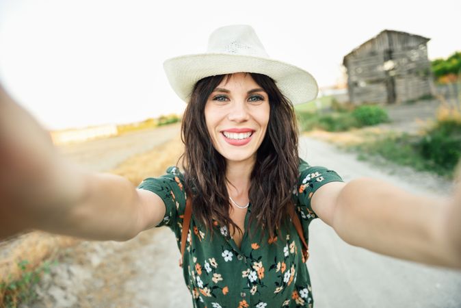 Happy brunette female taking a selfie