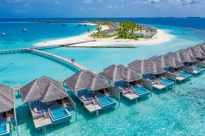 Drone shot of a row of back patios of holiday villas on tropical beach resort, landscape