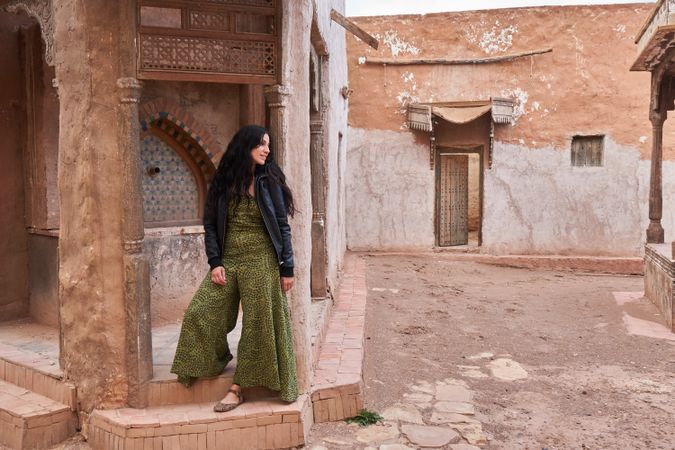 Woman on street between ancient buildings