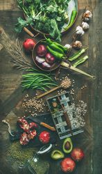 Fresh raw vegetables, fruit, grains, and oil ready for healthy dinner recipe