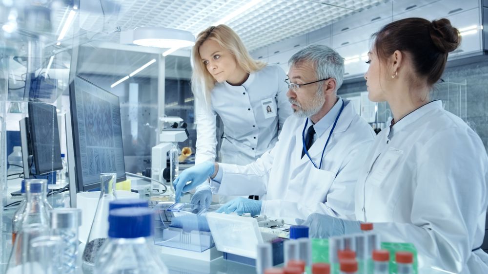 Team of Research Scientists Working With Personal Computer, Analysing Test Trial New Generation Drug Data.