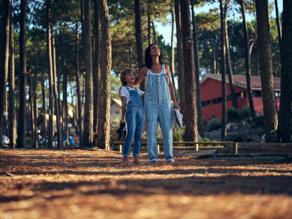 Mother and son in campsite at woods