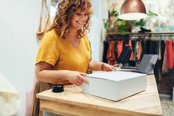 Woman preparing a package for delivery for an online order