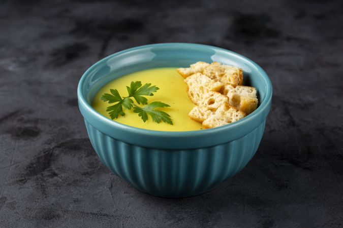 Bowl with onion soup and croutons on the table.