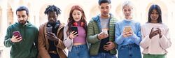 Banner of students checking their phones outside