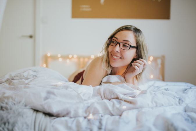 Woman lying in bed at home