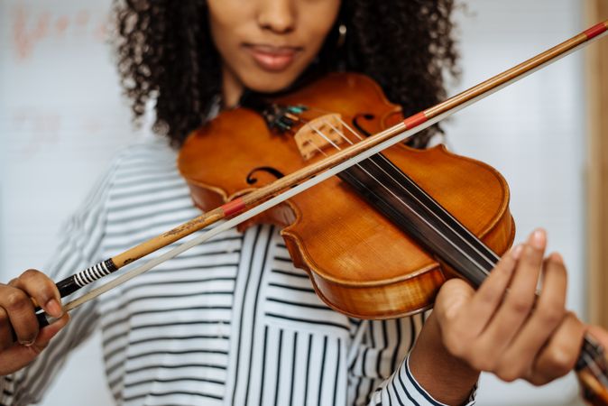 Woman playing violin in studio