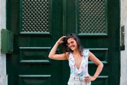 Confident stylish woman in sunglasses standing on city street
