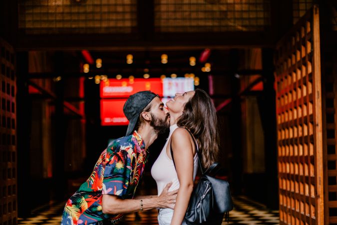 Laughing couple against building entrance