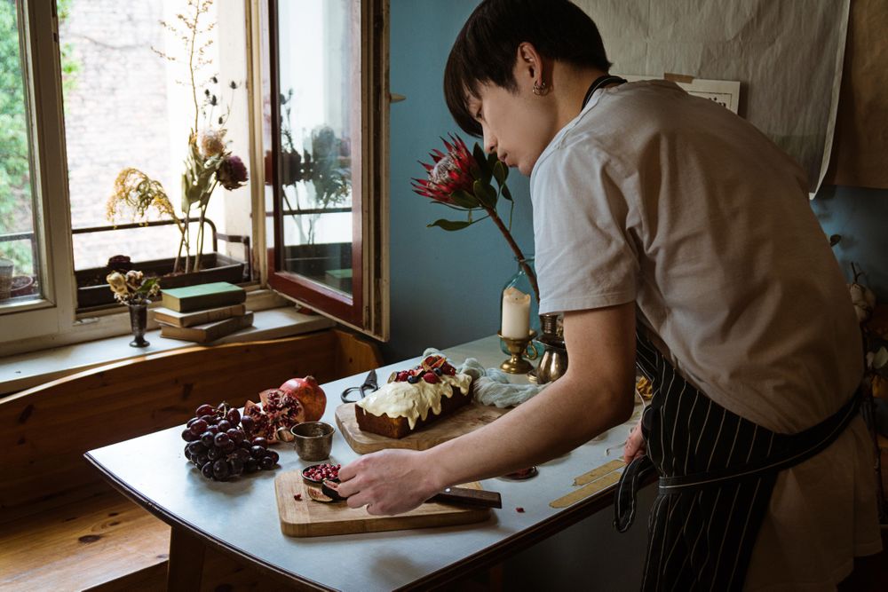 Man preparing cake in kitchen