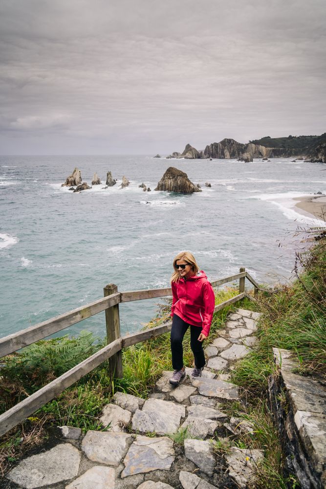 Woman climbing stairs that come from the seashore