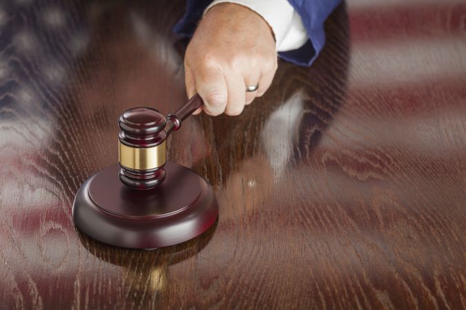 Judge Slams Gavel and American Flag Table Reflection