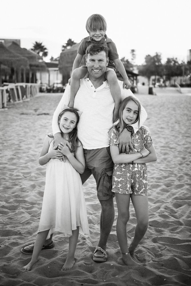 Man with daughters and son on beach