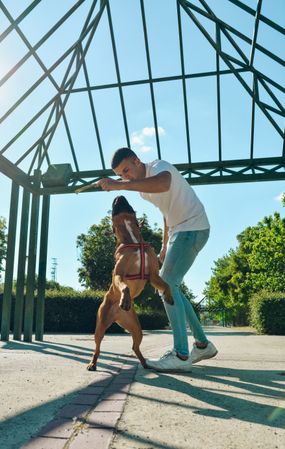 Man running and playing with his dog.