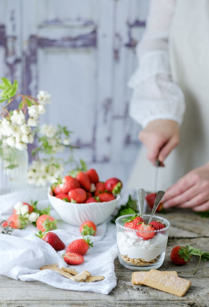 Confectioner cooking dessert of ripe strawberries