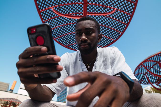 Black man using smartphone in city