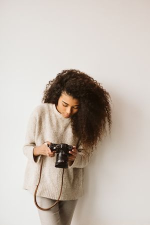 Cheerful Black woman with camera