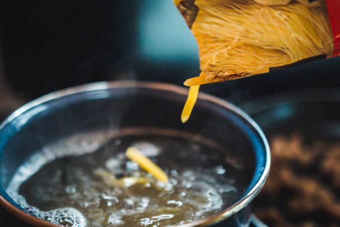 Pasta spilling into boiling water
