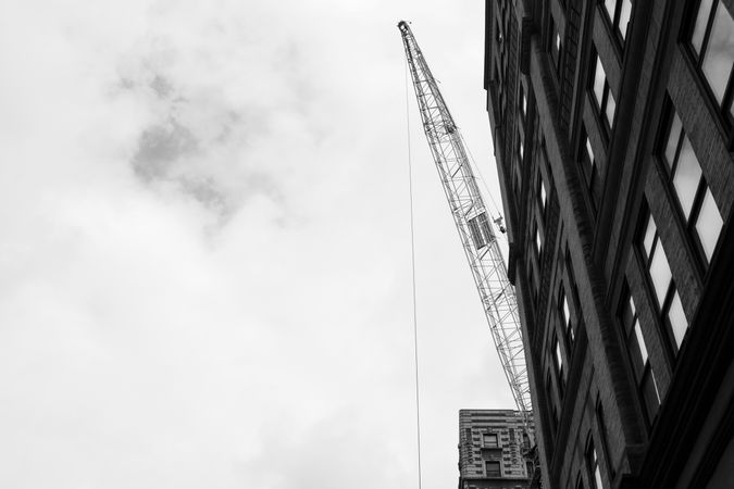 Crane at construction site in grayscale