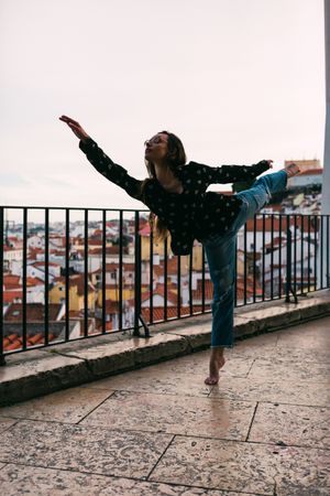 female dancer dancing against cityscape