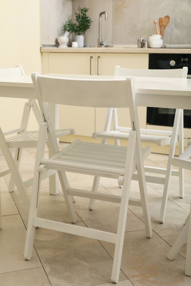 Kitchen interior with wooden table and folding chairs