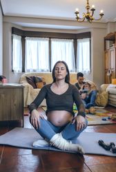 Pregnant woman exercising in the living room