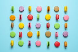 Macarons aligned on a blue background