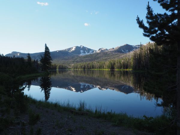 Dawn Reflections: Serene Lake in Yellowstone National Park