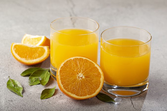 Glass with orange juice on the table.