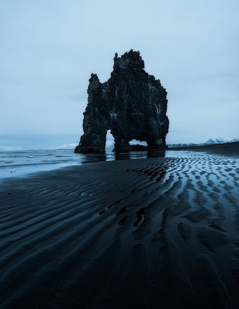 Rocky shoreline of sea in clouds in Iceland