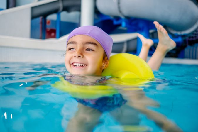girl with water wings in swimming pool