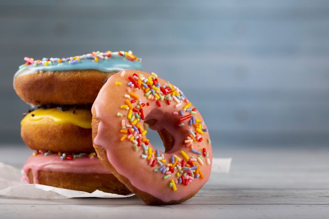 Delicious assorted colorful donuts on the table.