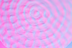 Ripples lit with vibrant bold gradient holographic colors