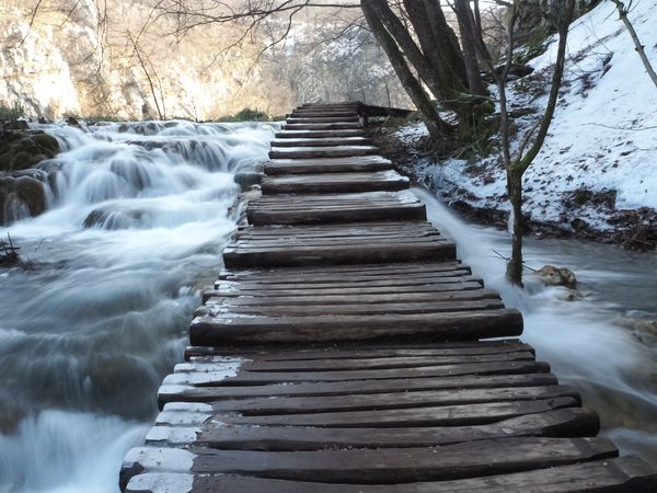 Wooden Foot Bridge over waterfalls.