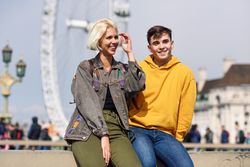 Man and woman friend relaxing in front of London Eye