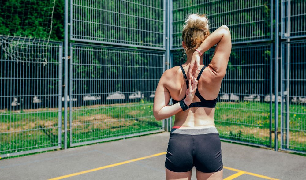Sportswoman doing arm stretches