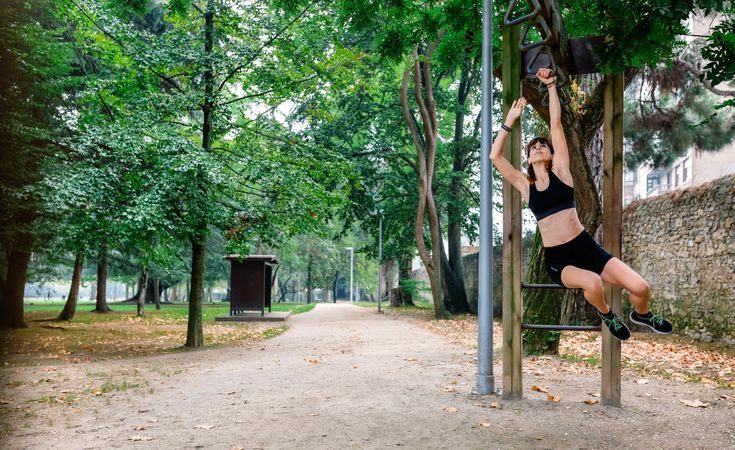 Woman doing monkey exercises on rings