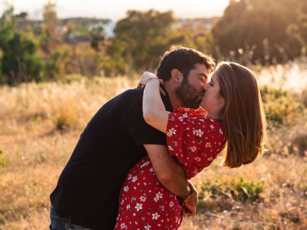 Young happy couple embracing in beautiful garden