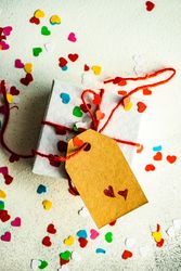 St. Valentine day concept with small gift and heart confetti