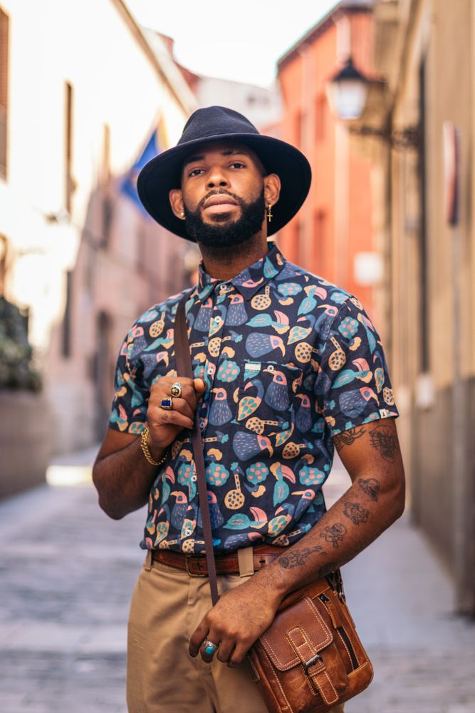 Stylish Black man walking on the city street