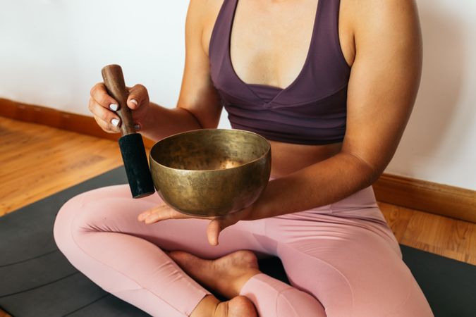 Woman in sportswear doing yoga and meditating at home
