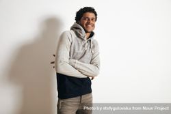 Man smiling with arms crossed in grey hoodie 4MzYlb