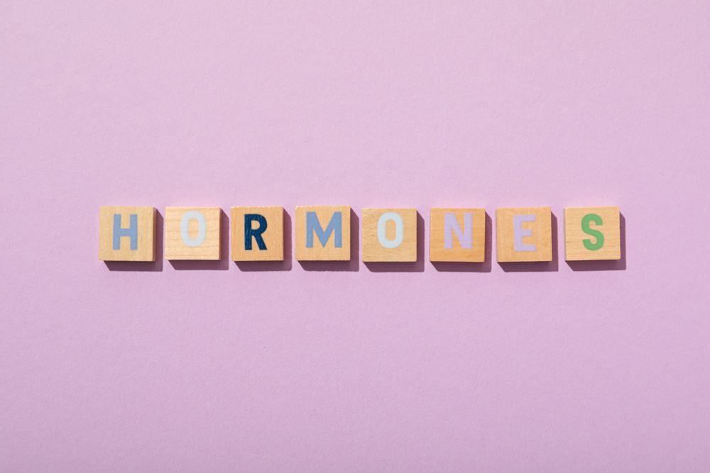 The word hormones on a light background.