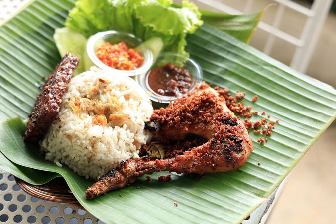 Nasi Liwet Ayam Rempah, Spiced Rice Served with Tempeh and Traditional Fried Chicken