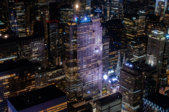 Scenic Aerial New York City View of Downtown Manhattan Architecture. Panoramic Shot of the Business District from a Helicopter. Cityscape with Buildings with Lights in Offices at Night