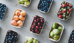 Diagonal rows of fresh fruit in eco-friendly boxed