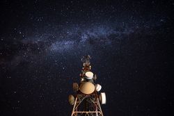Amazing view of transmission towers against Milky Way in night sky