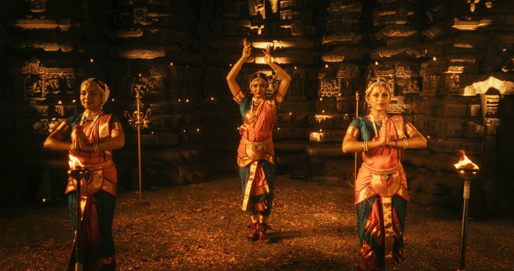 Mesmerizing Slow-Motion Portrait of Female Indian Dancer Expressing Herself Through Captivating Folk Dance Choreography Inside an Ancient Temple.